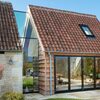 a frameless glass link between a traditional cottage and new timber extension