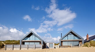 structural glass facade and gable end windows to beach home new build