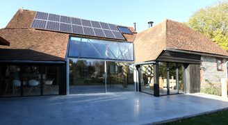 super slim framed sliding glass doors in a barn conversion