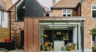 glass kitchen extension with slim glass doors and brown metal cladding