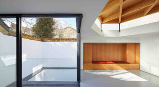 Corner opening sliding glass doors to glazed basement balcony in London new build home