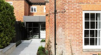 Modern rear extension with frameless rooflights and steel patio doors