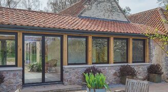 traditonal barn conversion with metal framed glazing