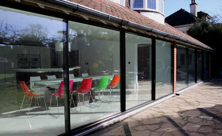 Slim framed sliding glass doors to rear extension of family home