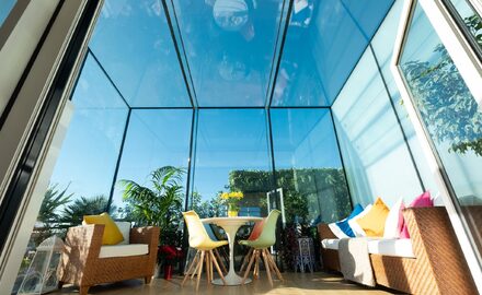 Large frameless structural glass roof extension