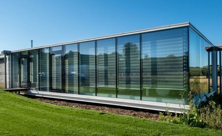 floor to ceiling structural glass walls with a casement door