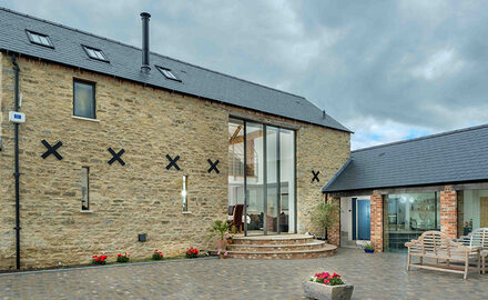 Contemporary barn conversion with oversized sliding glass doors