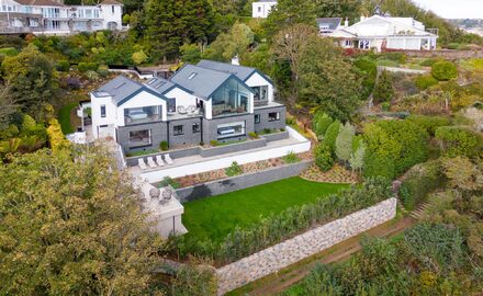 a large modern house set on a cliffside