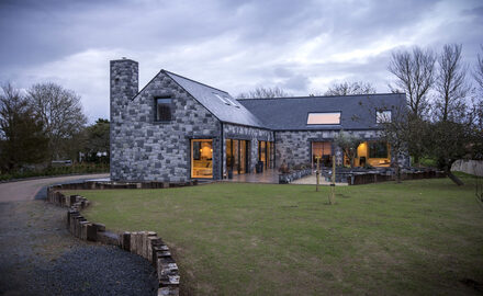 Traditional stone Guernsey new build with frameless fixed conservation rooflights for light filled living spaces