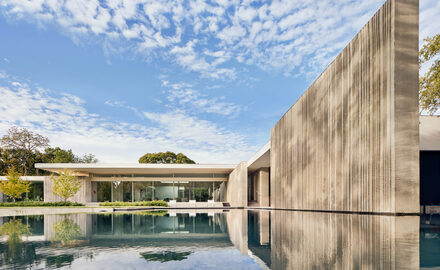 Luxury Dallas new build with concrete facades and slim sliding glass doors to modern living spaces