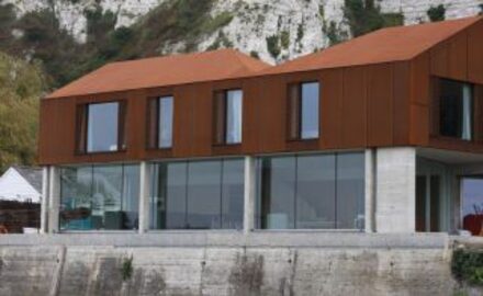 Riverside Rusty House with full height glass offers stunning river views