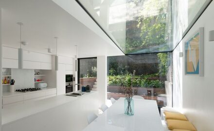 large strip rooflight over a white kitchen extension