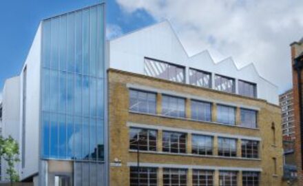 an external street view of an old warehouse which has been converted into offices with a sustainable design