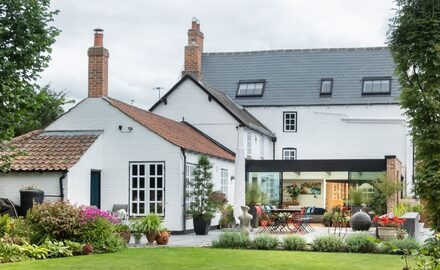 traditional home with glass box extension