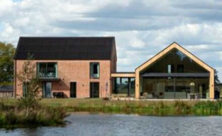 modern two wing farmhouse in Leicester overlooking a lake