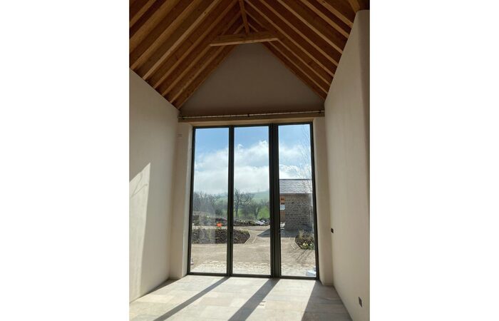 Ultra tall bifolding doors to renovated Ennox Farm