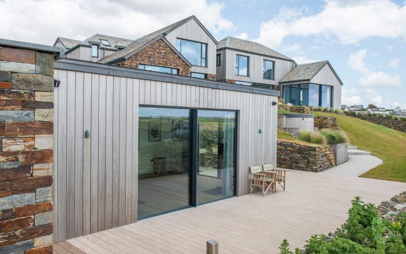 minimal windows sliding glass doors extend the views from within the cliffside home's gym