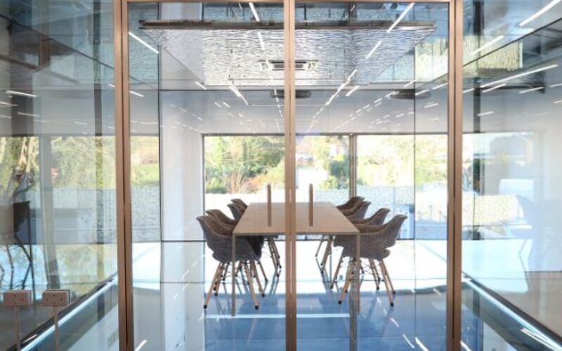 unique internal glass hinge doors with slim aluminium framing at a glazing showroom