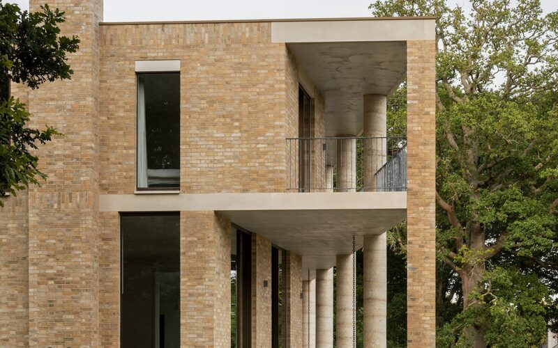 Colonnaded terrace overlooks National Park through ultra slim framed sliding glass doors and casement windows.