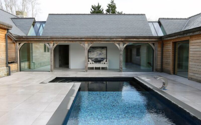 contemporary barn conversion with sliding doors and structural glazing