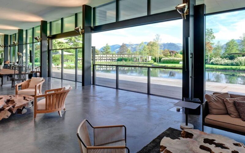 glass walls sinking below the floor overlooking a lake