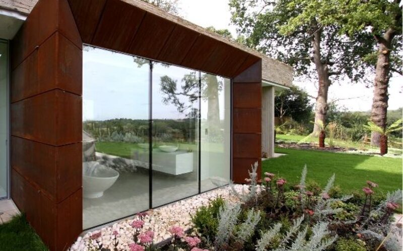 frameless structural glass window to bathroom with corten reveal