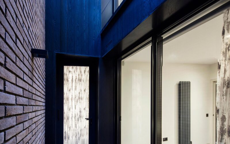 a small courtyard with patio doors and glass doors