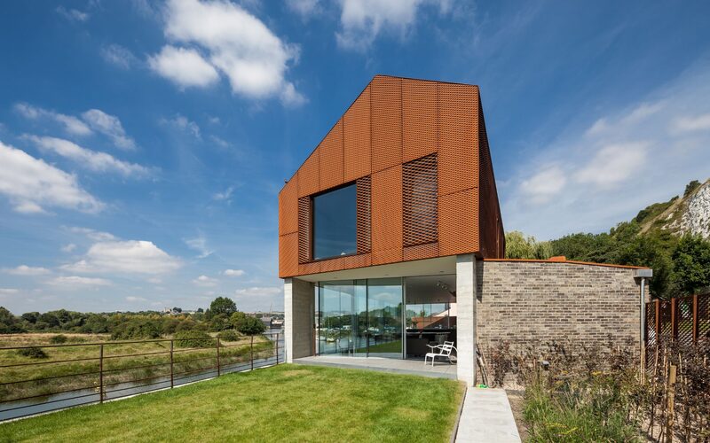 Beautiful contemporary riverside dwelling offers views through the slim framed full height glass.