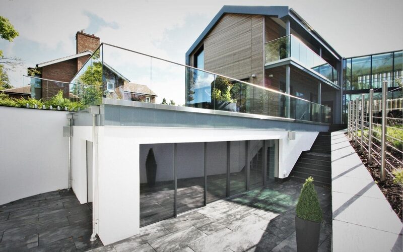 highly glazed sustainable home design with slim framed glazing and glass balustrades