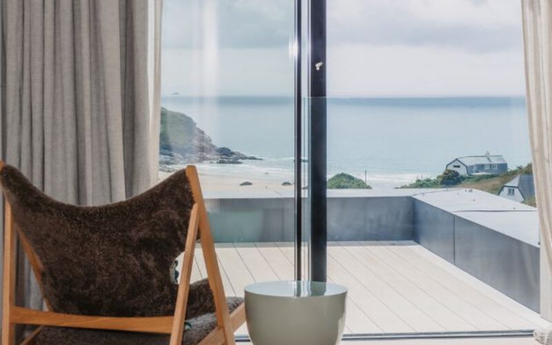 frameless glass juliet balcony overlooking beach at mawgan porth cornwall