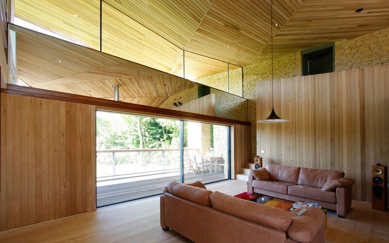 large glass sliding doors set into a timber wall as part of a sustainable home project