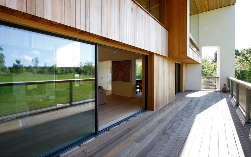 large glass sliding doors set into a timber wall shown open with flush threshold