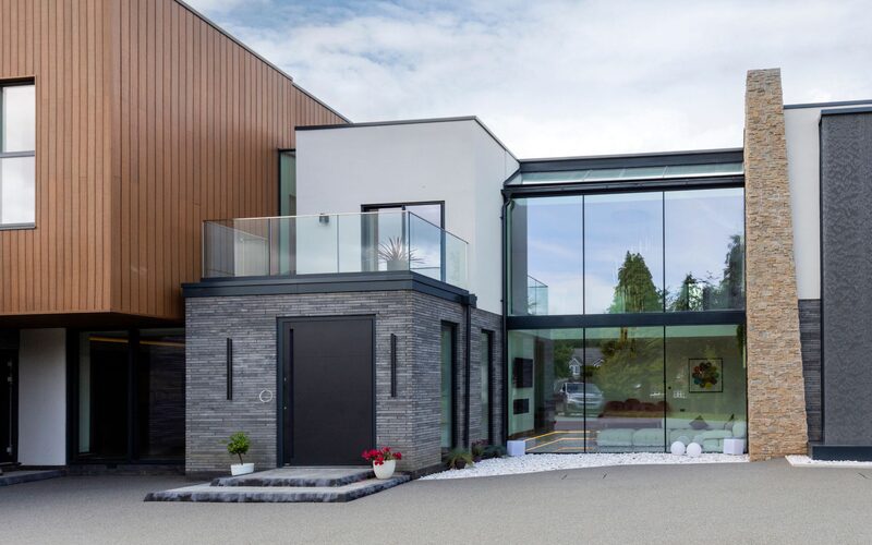 Structural frameless glass to luxury new house in Little Aston creates an atrium oozing curb appeal.