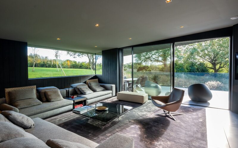 a living room with large glazing doors and windows