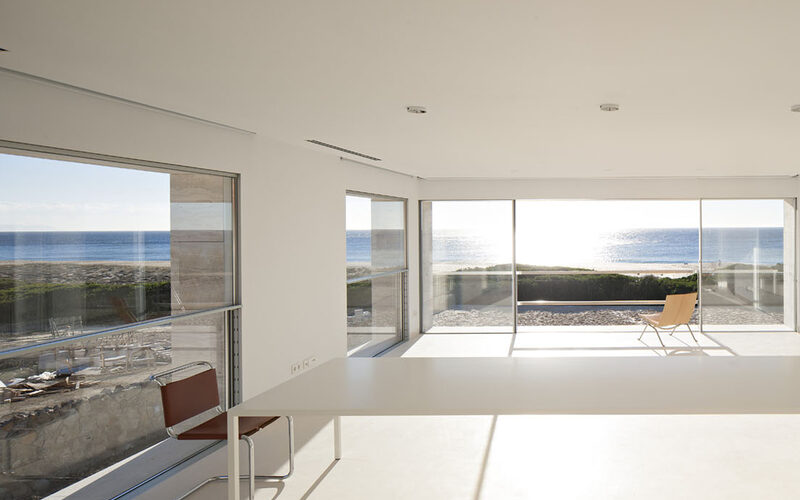 Vertical sash windows and slim sliding doors to beach home in Spain