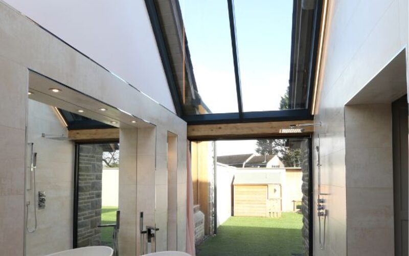 contemporary barn conversion with sliding doors and structural glazing