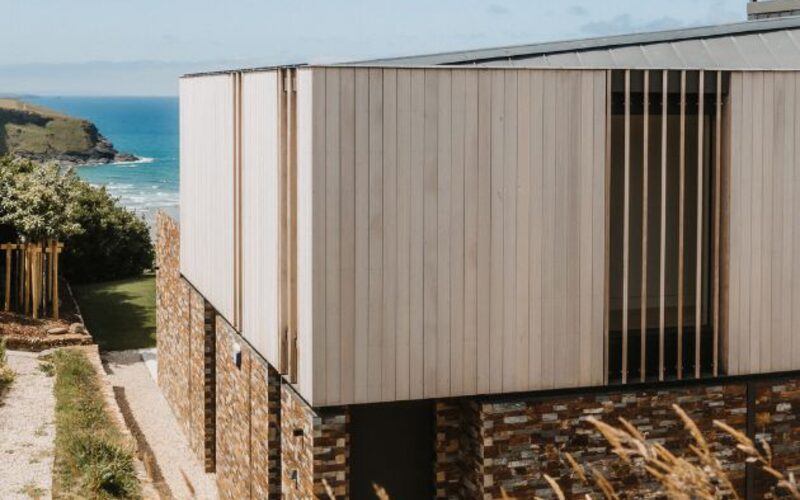 timber clad house overlooking beach at mawgan porth cornwall