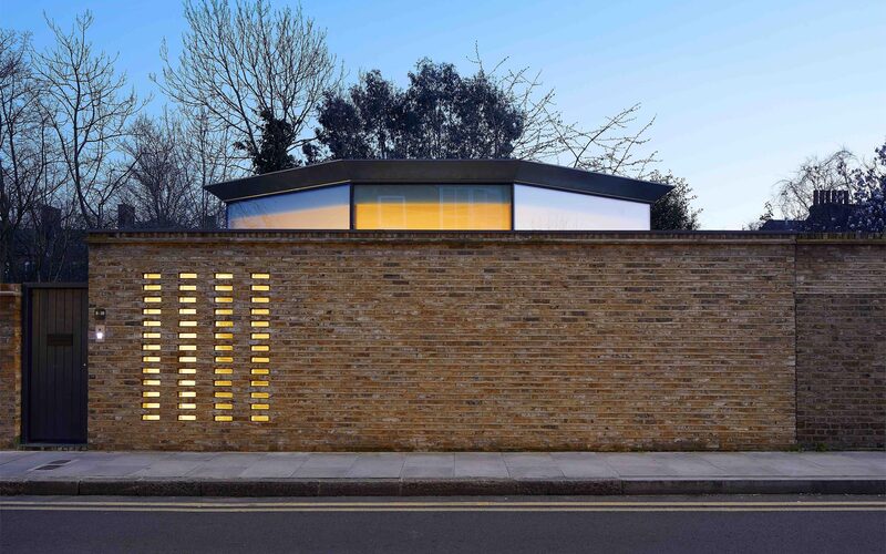 New build home with unique glass clerestory windows below roof extension