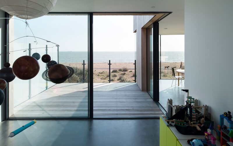 looking out through open corner doors to the beach on old fort road