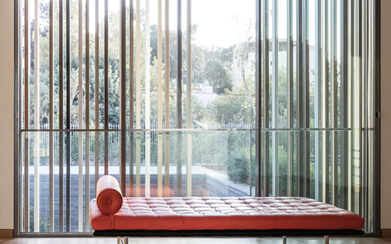 Large frameless picture window with outer timber cladding for privacy