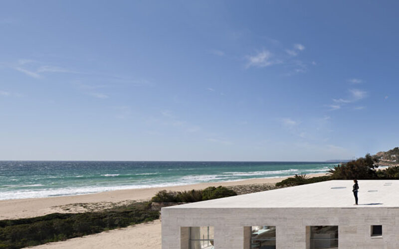 Slim framed structural glass windows overlooking beach