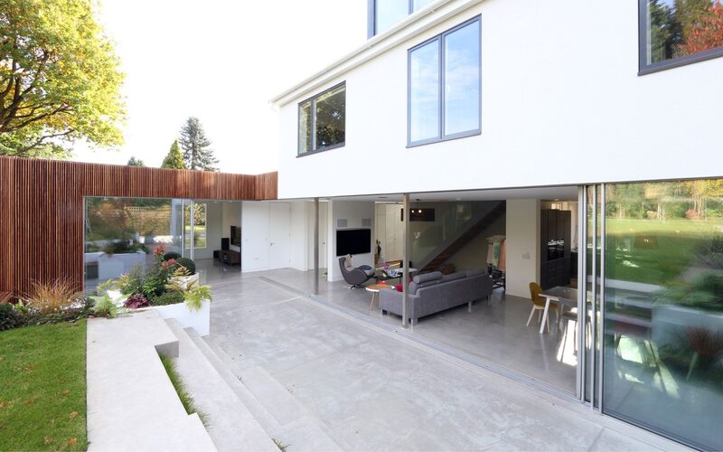 Wooden clad extension with slim framed sliding doors