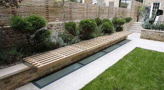 Glass rooflight in garden above basement renovation