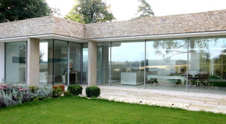 minimally framed sliding glass walls in luxury new build home