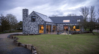 Traditional stone Guernsey new build with frameless fixed conservation rooflights for light filled living spaces