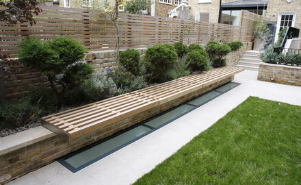 Glass rooflight in garden above basement renovation