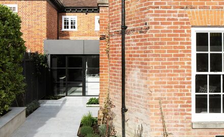 Modern rear extension with frameless rooflights and steel patio doors