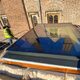 oversized venting rooflight on a roof with a man in a high vis stood to the left of it