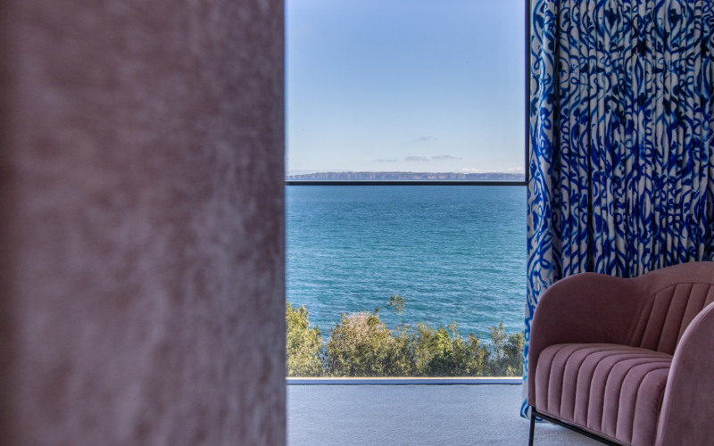 vertical sash windows with slim horizontal frames overlooking the sea in Guernsey